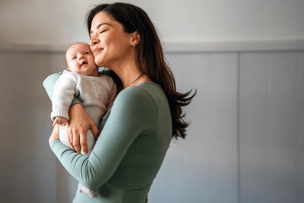 loving-mother-carrying-her-newborn-600nw-2484587947