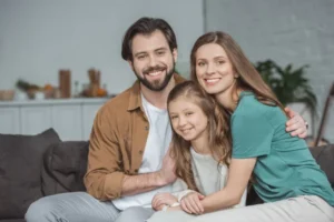 stock-photo-happy-parents-daughter-looking-camera-home