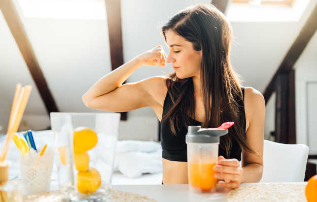 Woman,At,Home,Drinking,Orange,Flavored,Amino,Acid,Vitamin,Powder.keto